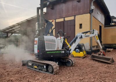 Ein Bagger im Einsatz zur Erdbewegung auf einer Baustelle im Landschaftsbereich.